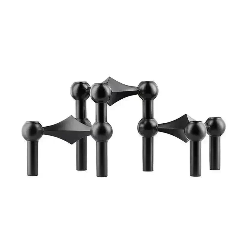 Trois modules noirs mats posés côte à côte sur fond blanc, vue de face avec têtes sphériques et liaisons en losange. 11