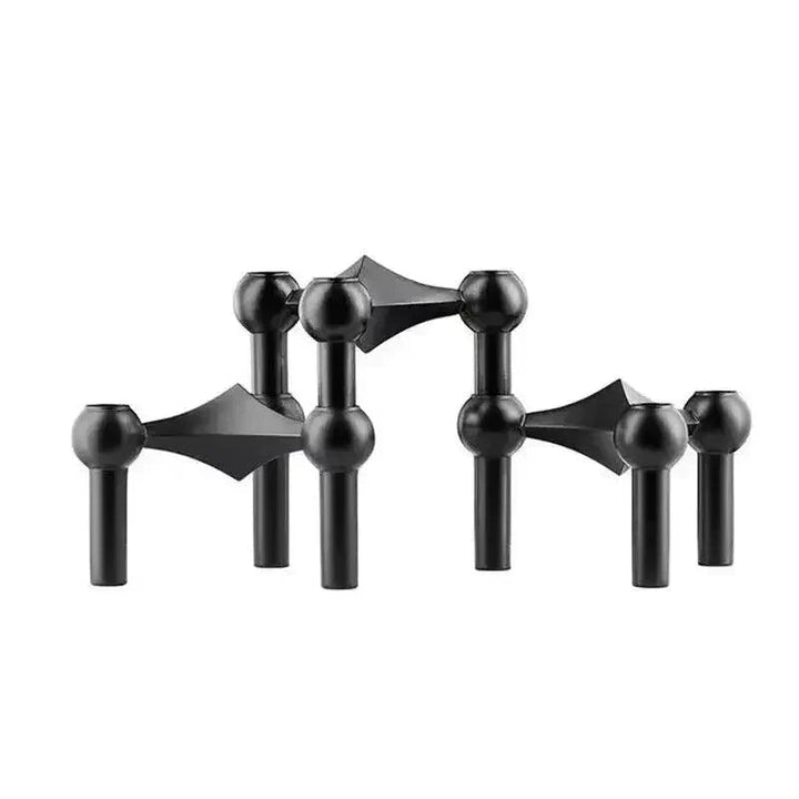 Trois modules noirs mats posés côte à côte sur fond blanc, vue de face avec têtes sphériques et liaisons en losange. 11