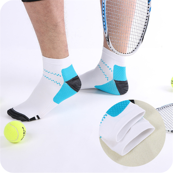 Homme en chaussettes blanches basses à talon bleu et gris, près d'une balle de tennis, avec zoom sur le bord. 3