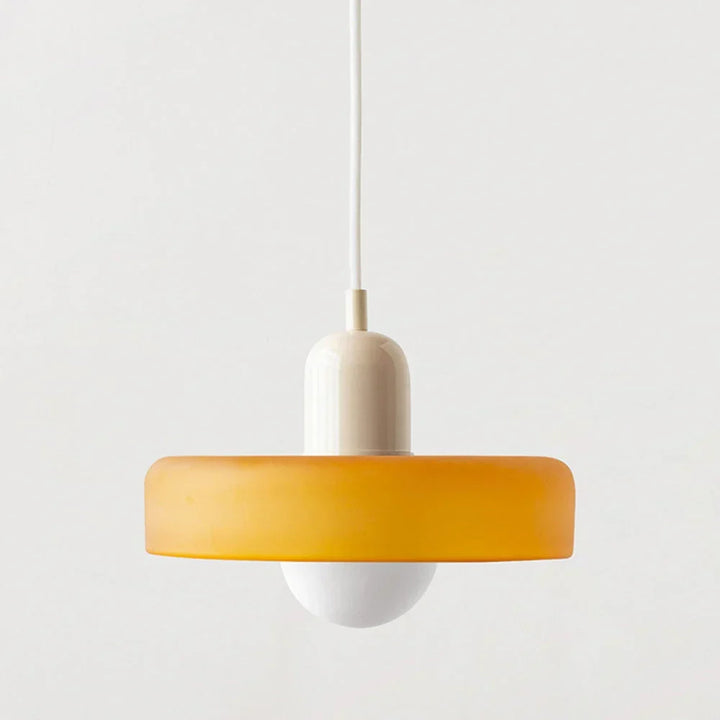 Suspension à abat-jour orange safran, capuchon crème et câble blanc, globe blanc dessous, sur fond neutre. 10