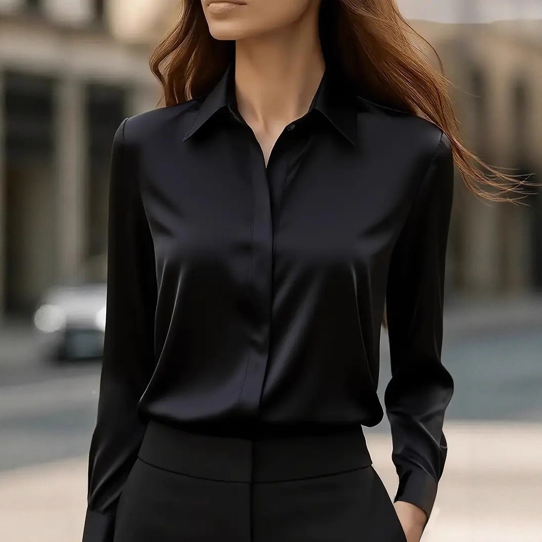 Blouse noire satinée portée avec un pantalon noir, vue de face en extérieur 1