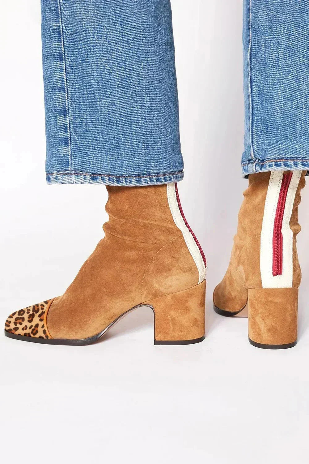 Bottines en daim camel à bout imprimé léopard, zip rouge sur bande blanche au dos, portées avec un jean. 6