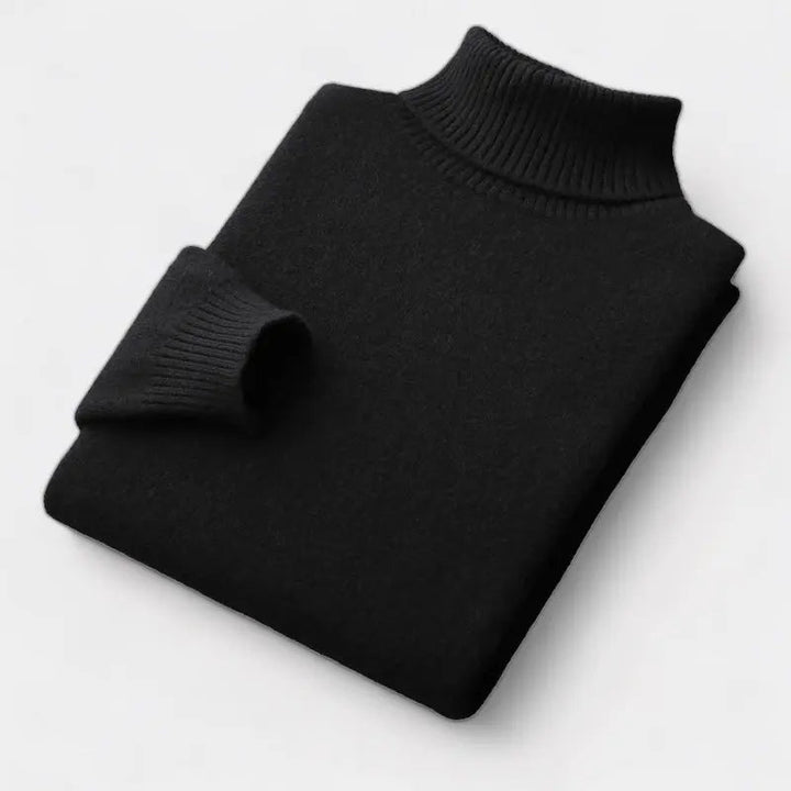 Pull à col roulé noir plié à plat, manche repliée sur le devant 5