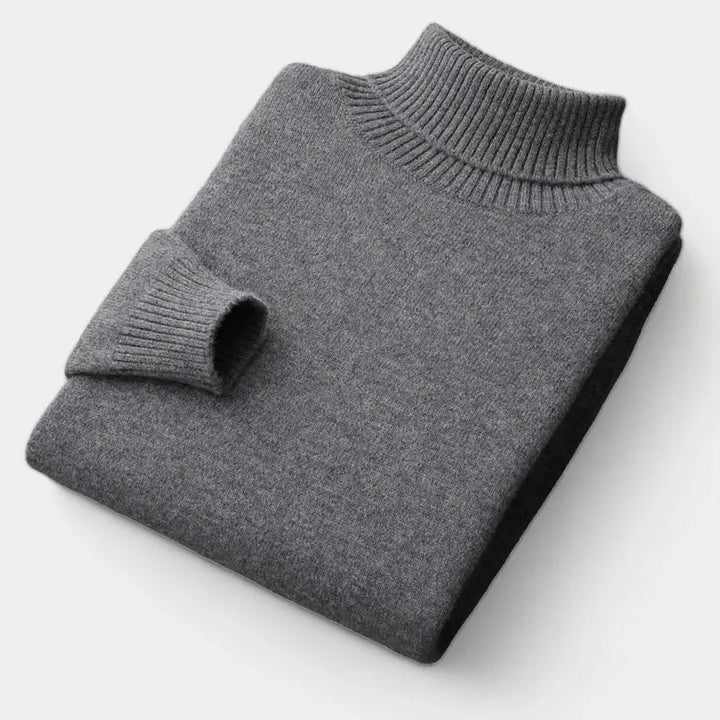 Pull à col roulé gris foncé plié à plat, manche repliée montrant le poignet côtelé 3