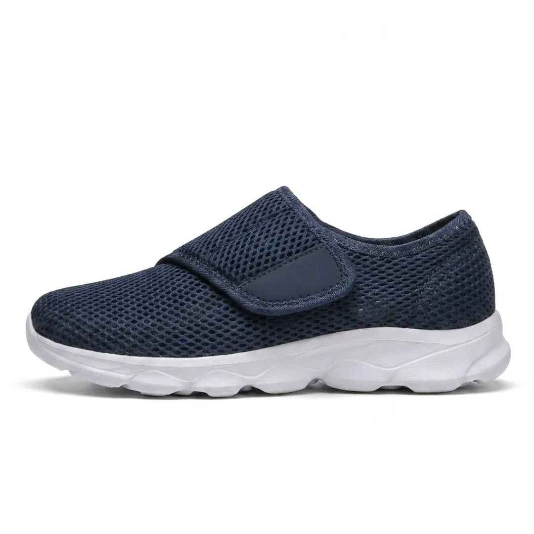 Vue de profil d'une chaussure bleu marine en mesh aéré avec large sangle auto-agrippante et semelle blanche épaisse. 1