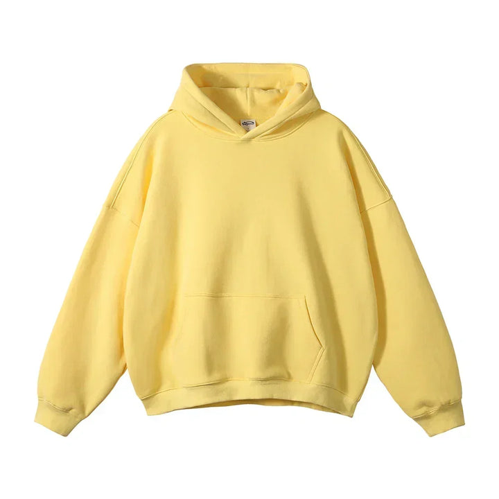 Face avant du sweat à capuche jaune pâle, avec poche kangourou et poignets côtelés, présenté à plat sur fond blanc. 19