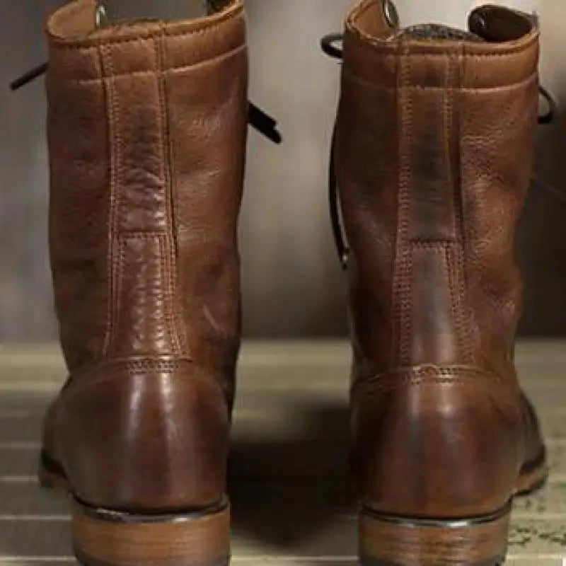 Vue de dos des bottes en cuir brun, avec les coutures verticales et le talon bas. 2
