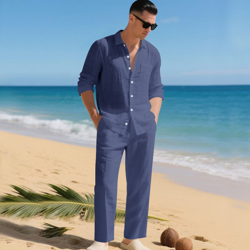 Homme debout sur la plage, ensemble chemise à poche poitrine et pantalon en bleu marine, manches retroussées. 6