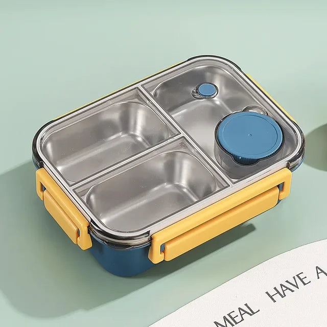 Boîte repas bleu marine vide aux fermoirs jaunes, couvercle transparent fermé sur trois compartiments en inox et petit pot rond bleu. 13