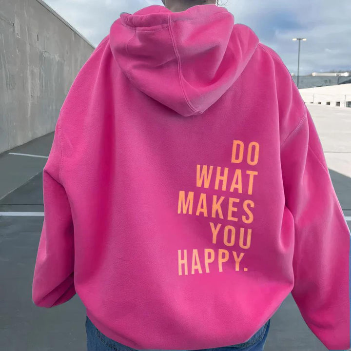 Vue de dos d'un sweat à capuche rose vif porté par un mannequin, avec un message imprimé en orange clair dans le dos. 3