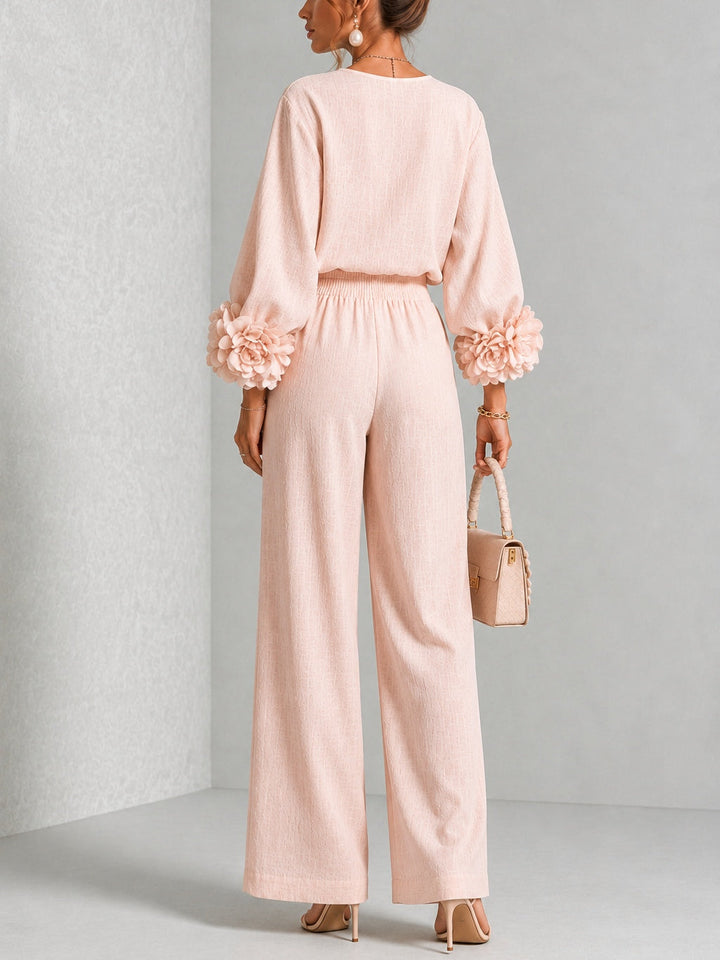 Vue de dos de l'ensemble rose pâle, taille élastiquée, manches fleuries et pantalon large 9