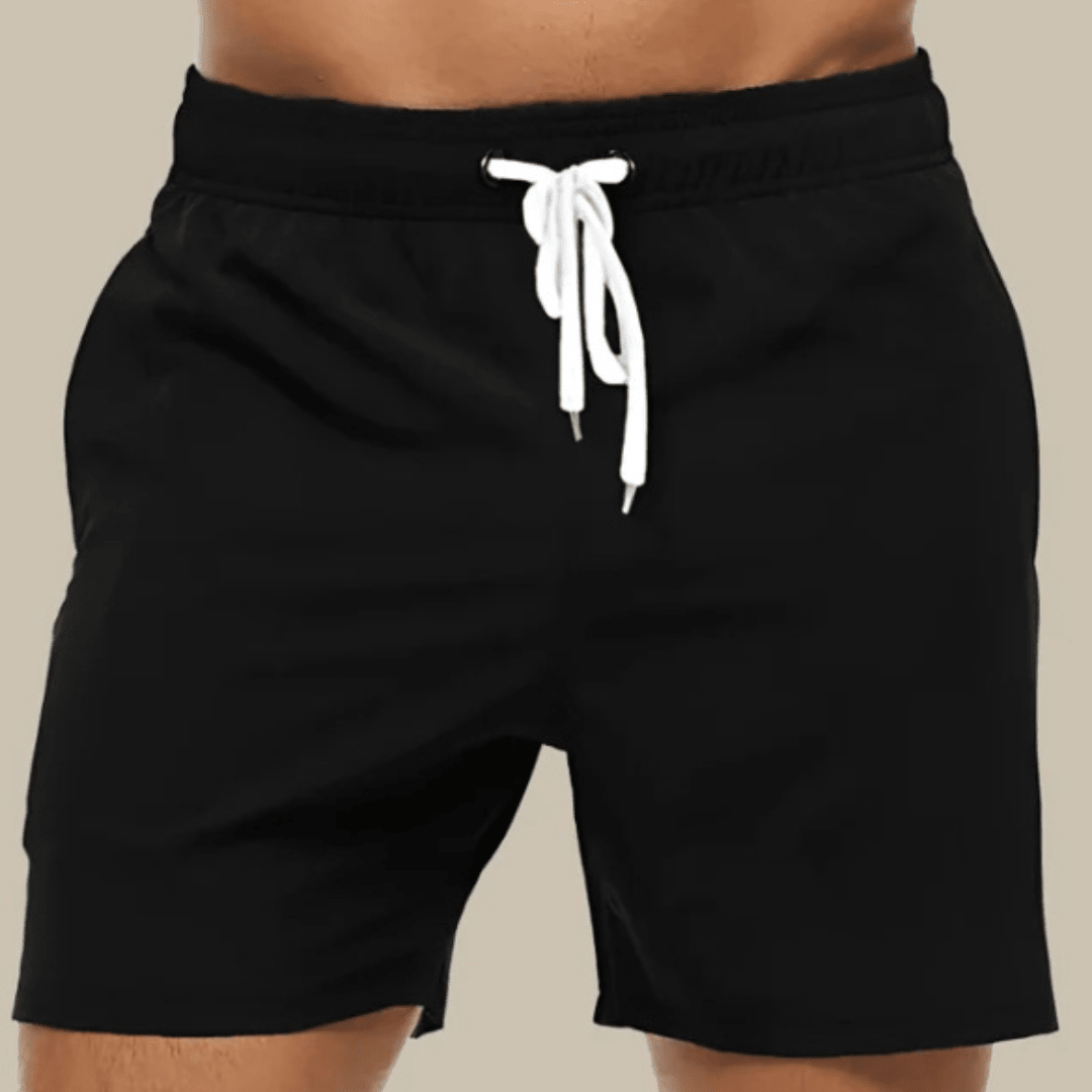 Gros plan face avant d'un short de bain noir à ceinture élastique et cordon blanc noué. 2