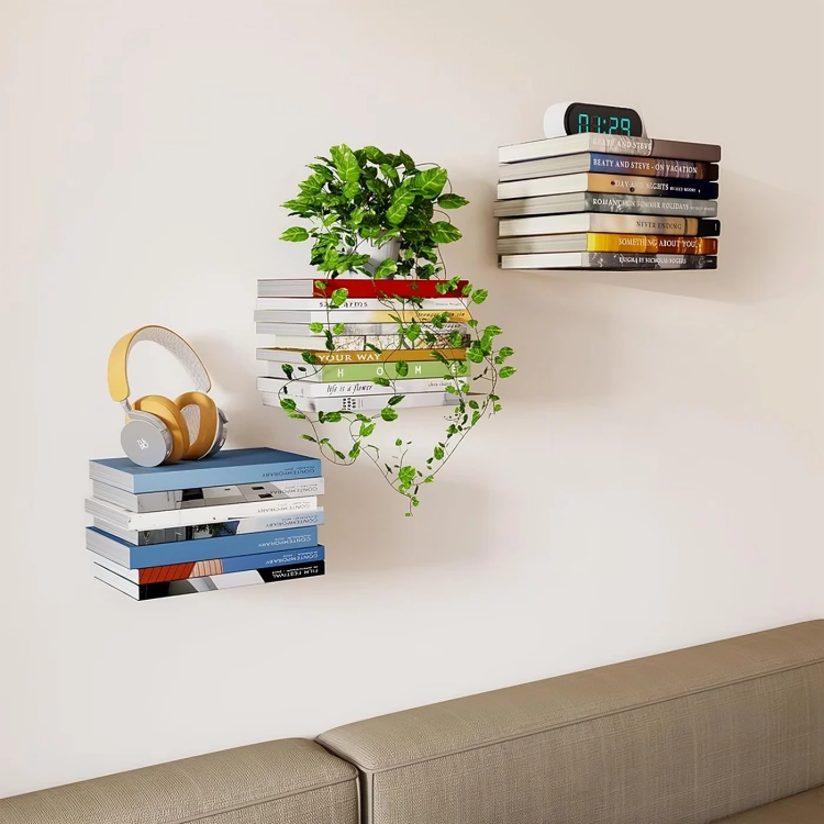Trois piles de livres flottantes sur un mur clair au-dessus d'un canapé, portant un casque audio jaune, une plante verte et un réveil. 5