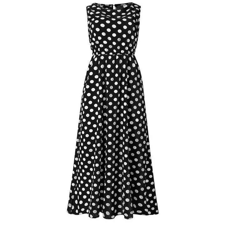 Robe longue noire à pois blancs, vue de face à plat sur fond blanc, taille élastiquée et jupe évasée. 7
