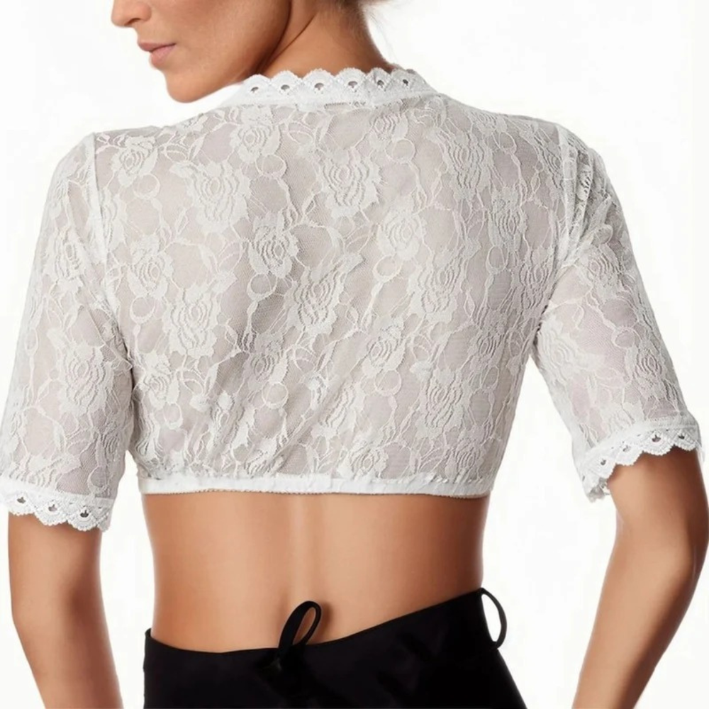 Vue de dos portée par un mannequin : dentelle florale transparente, manches courtes à bord festonné, jupe noire à lacet. 2