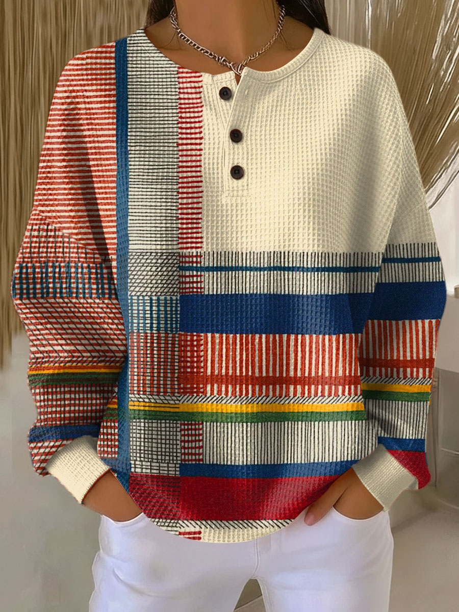Pull gaufré beige à trois boutons, côté gauche en rayures colorées rouges, bleues, jaunes et vertes, vue de face. 6