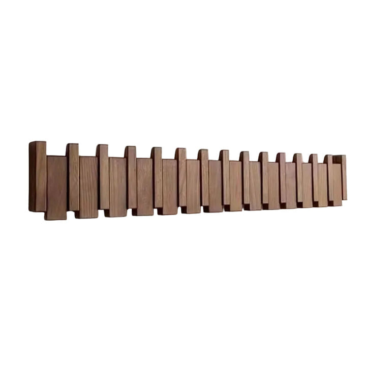 Longue barre murale en bois brun foncé aux lattes décalées comme des touches de piano, présentée seule sur fond blanc. 1