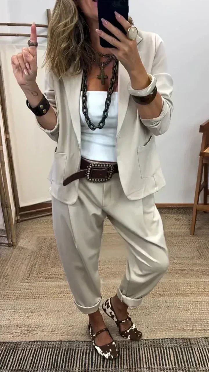 Femme en miroir portant l'ensemble beige clair, blazer à poches plaquées et pantalon ample aux bas retroussés, avec ceinture marron. 2