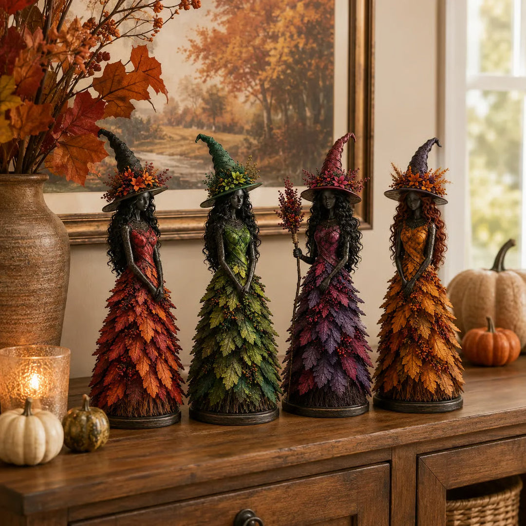 Les quatre sorcières rouge, verte, violette et dorée alignées sur un buffet en bois, devant un tableau de forêt d'automne et des citrouilles. 7