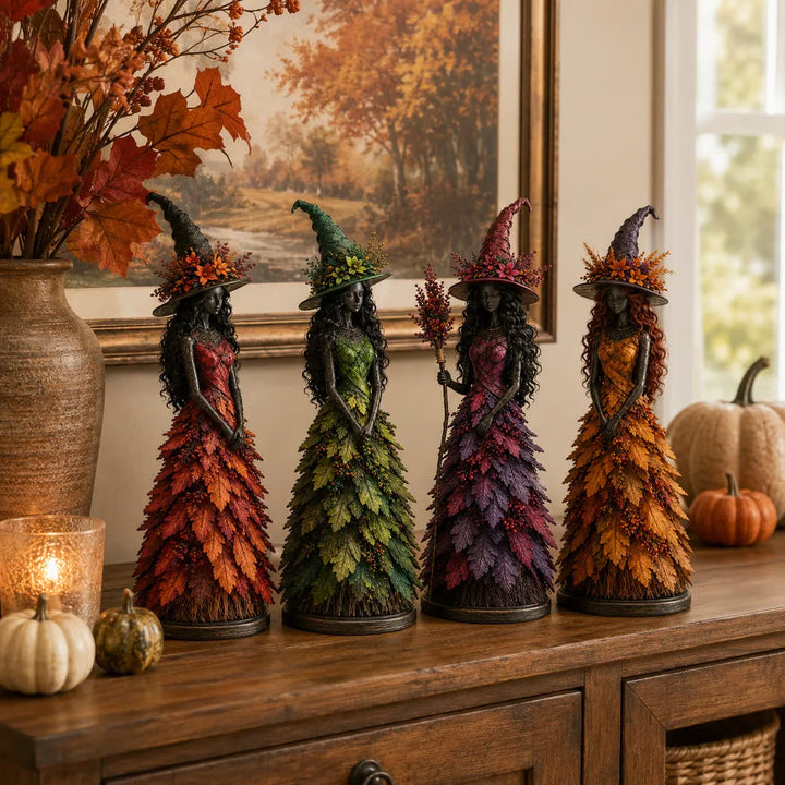 Les quatre sorcières rouge, verte, violette et dorée alignées sur un buffet en bois, devant un tableau de forêt d'automne et des citrouilles. 7