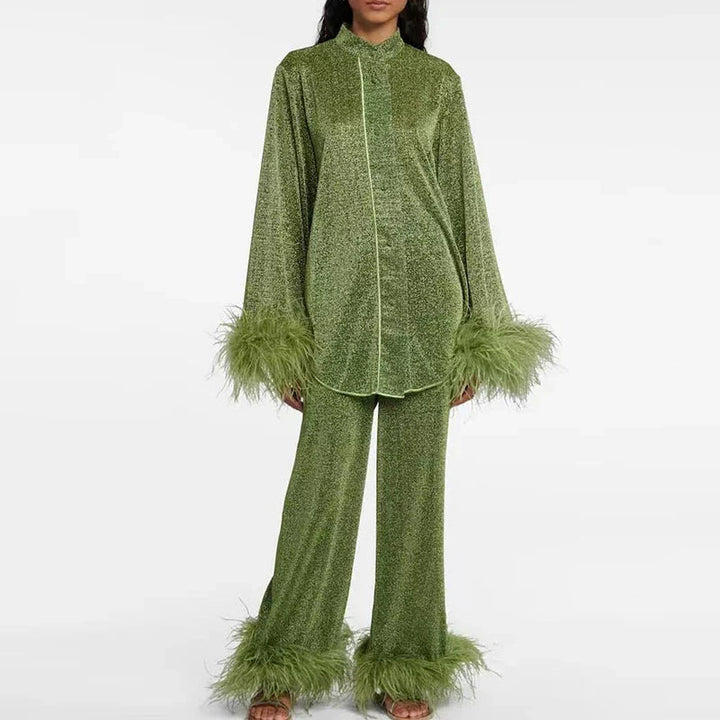 Femme en ensemble vert mousse scintillant avec liseré clair, longue chemise à col montant et pantalon droit bordés de plumes. 4