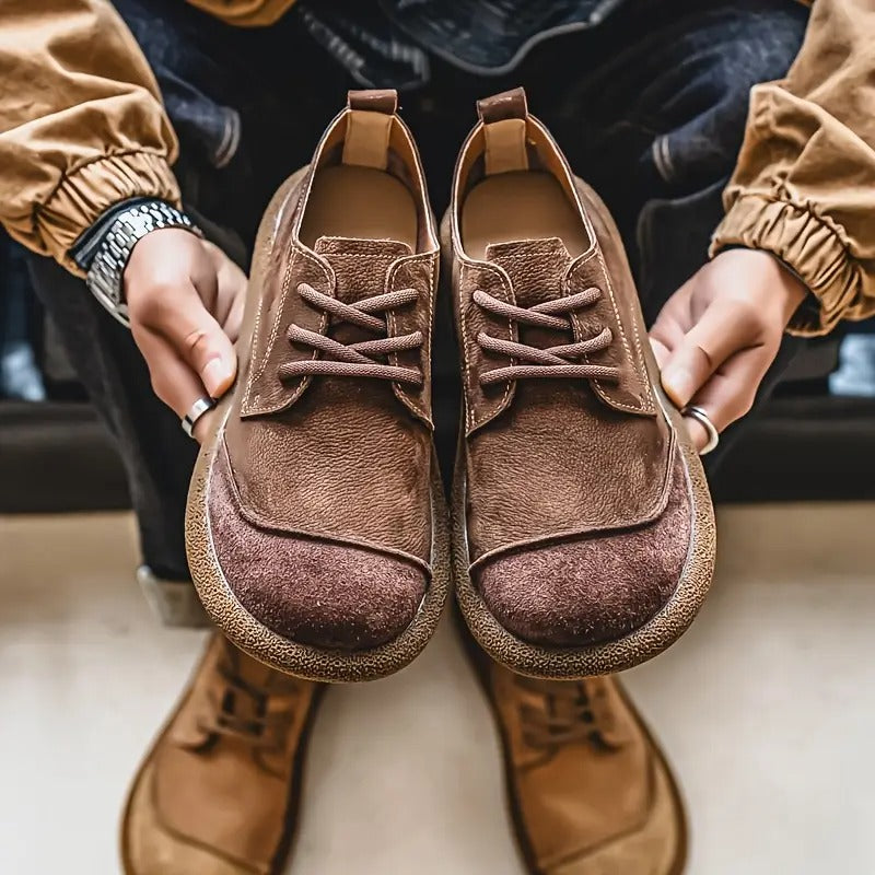Paire marron présentée à deux mains face à l'objectif, avec en dessous une paire beige posée au sol. 9