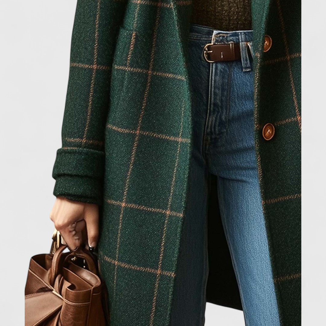 Détail du bas du manteau côté gauche, avec manche retroussée, poche plaquée et main tenant un sac en cuir marron. 4