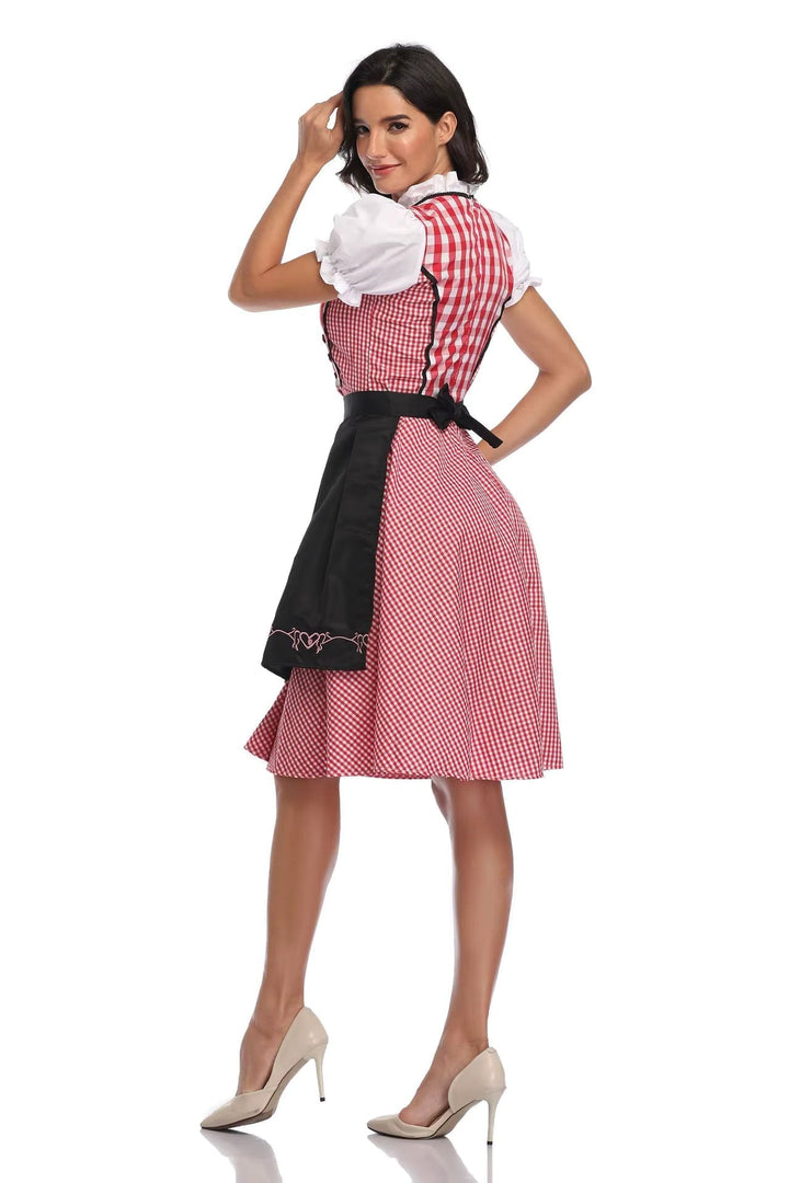Dirndl à carreaux rouges vu de dos, avec grand nœud du tablier noir et manches bouffantes blanches. 2