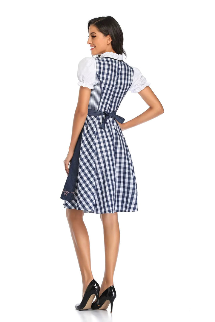 Dirndl à carreaux bleu marine et blancs vu de dos, avec manches bouffantes et tablier bleu noué dans le dos. 6