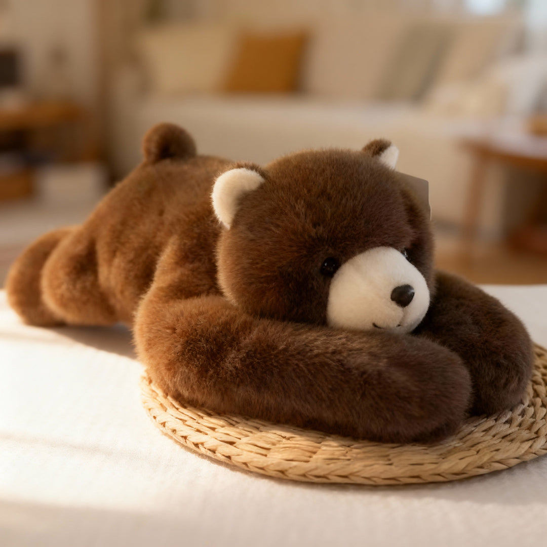 Ours en peluche brun foncé au museau crème, allongé sur un set de table en paille, longs bras repliés devant lui. 14