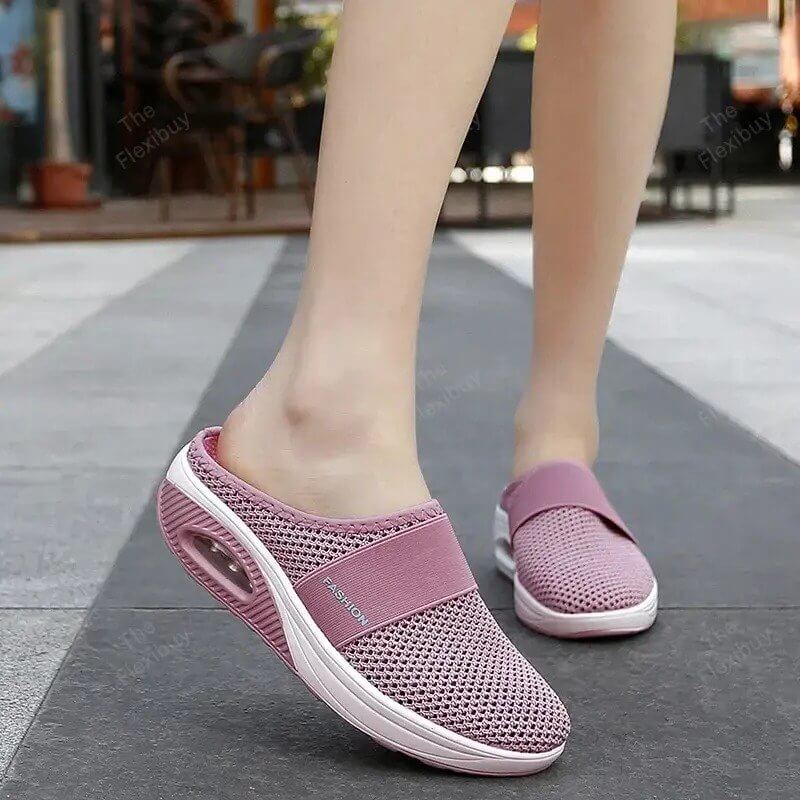 Mules roses en maille portées en marchant dehors, avec bande élastique et semelle blanche à coussin d'air 4