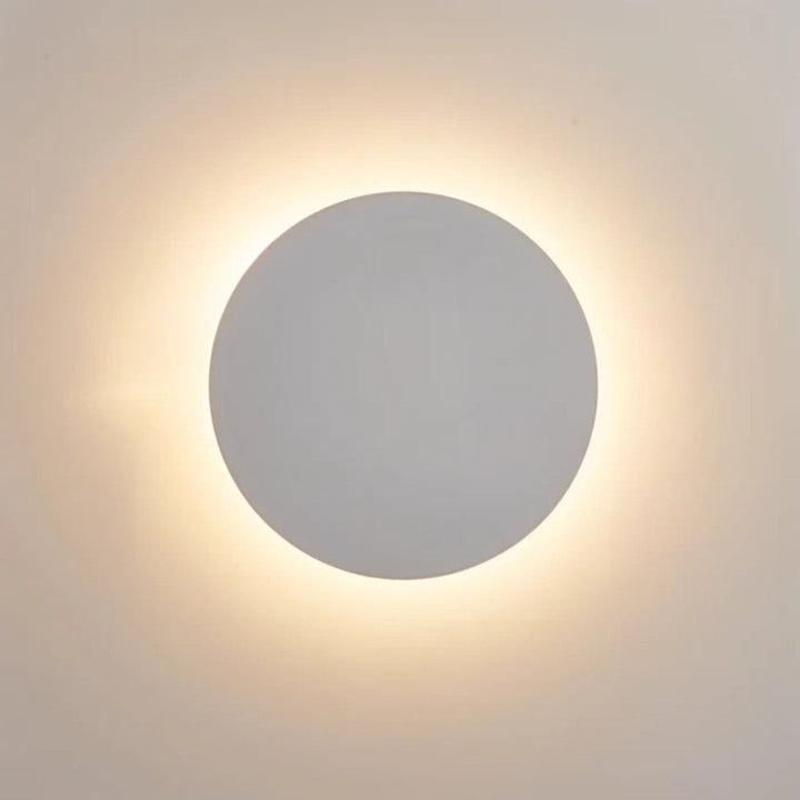 Disque blanc vu de face, éclairé en arrière-plan par un halo de lumière chaude 3