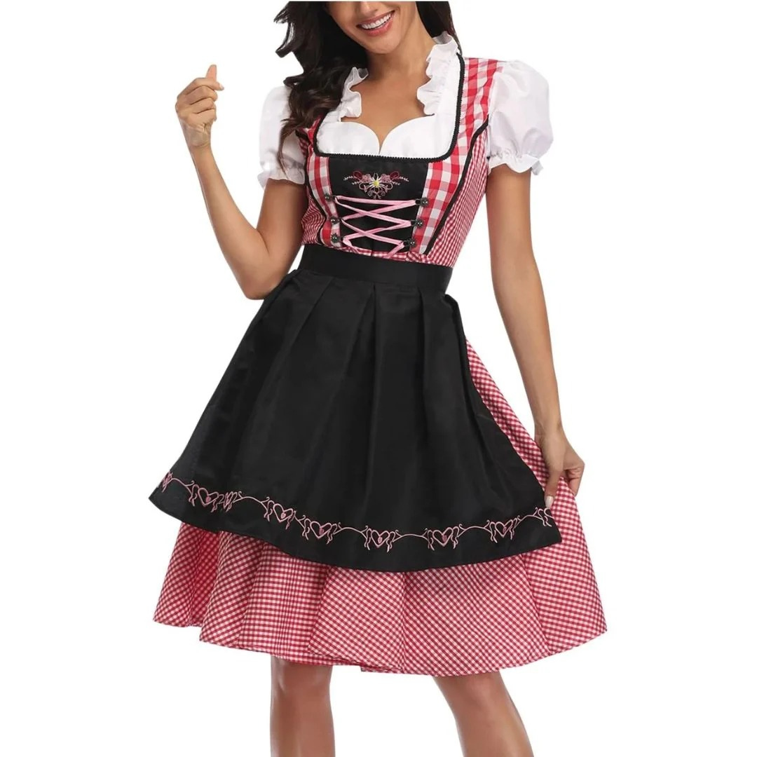 Femme souriante portant la robe à carreaux rouges et blancs avec tablier noir brodé de cÅ“urs, vue de face, corsage lacé rose. 1