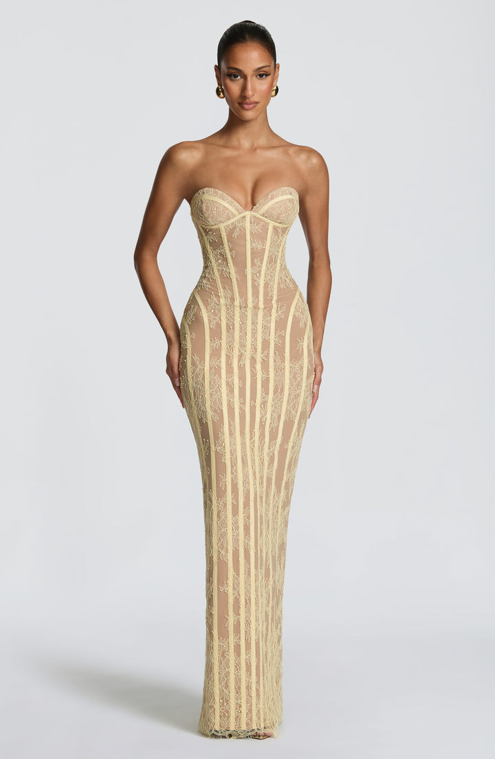 Robe longue jaune pâle en dentelle florale portée de face, bustier sans bretelles à baleines verticales. 17