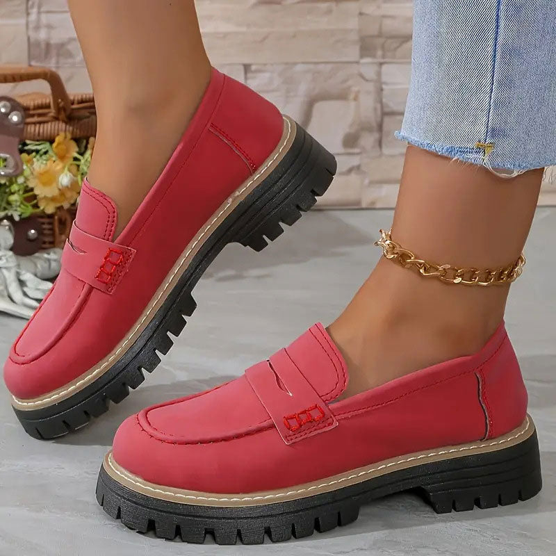 Mocassins rouges portés avec une chaîne de cheville dorée, surpiqûres rouges sur la bride et plateforme noire. 13