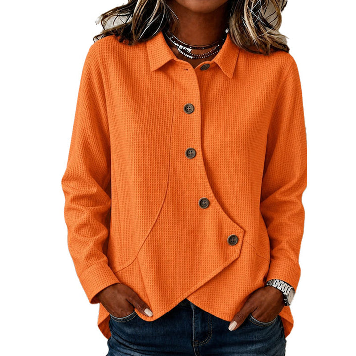 Version orange du haut en maille gaufrée à boutons marron, portée avec un jean, manches longues et bas asymétrique. 4