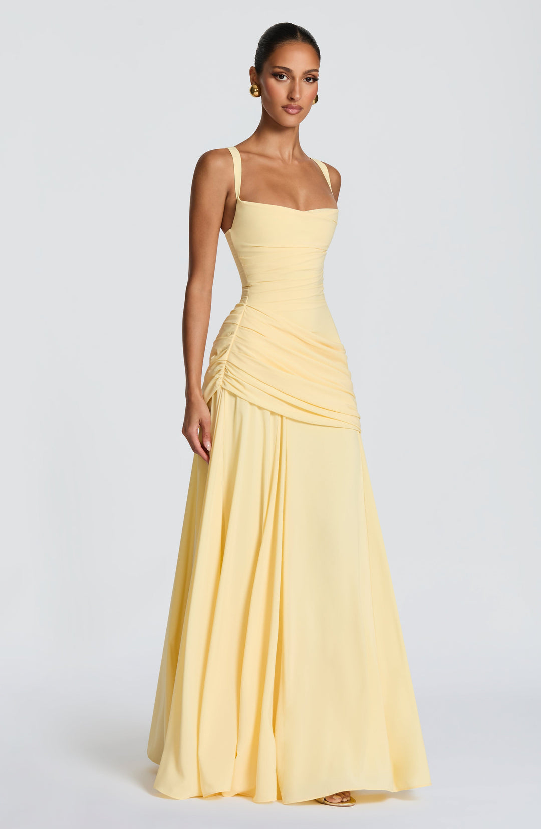 Robe longue jaune pâle portée de trois quarts, avec encolure carrée, taille ajustée et ample jupe fluide. 3