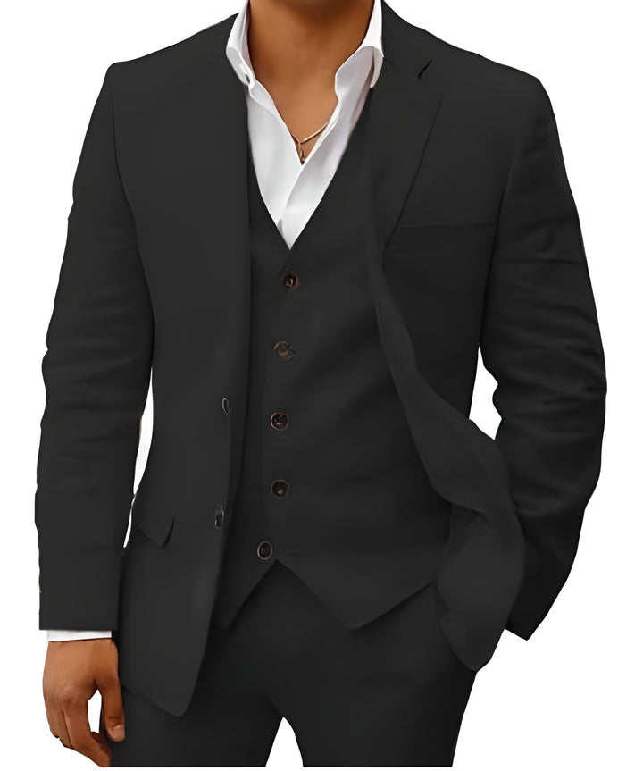 Même costume en noir, buste cadré, veste à revers cranté ouverte sur le gilet boutonné et la chemise blanche. 11