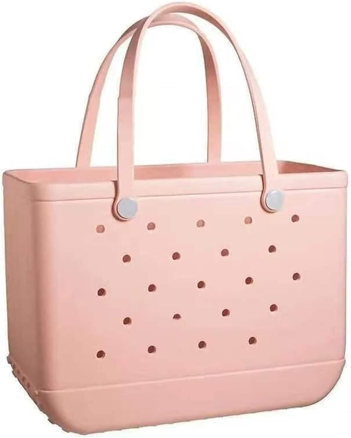 Cabas rose pâle ajouré vu de face sur fond blanc, avec longues anses souples et boutons de fixation clairs. 20