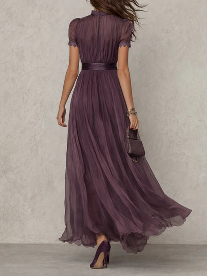 Robe longue prune vue de dos, avec fermeture boutonnée, col en dentelle, ceinture froncée à la taille et ample jupe en voile. 3